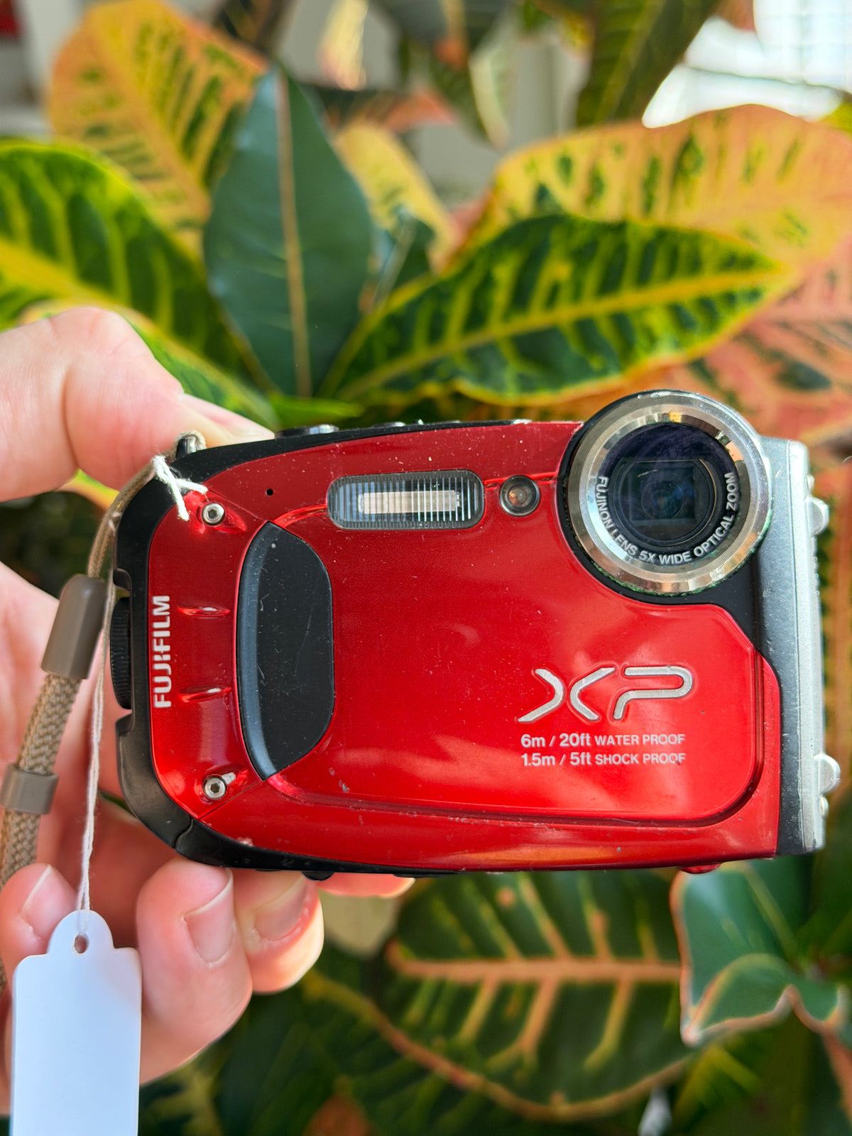 Fujifilm FinePix XP60 digital camera held in hand