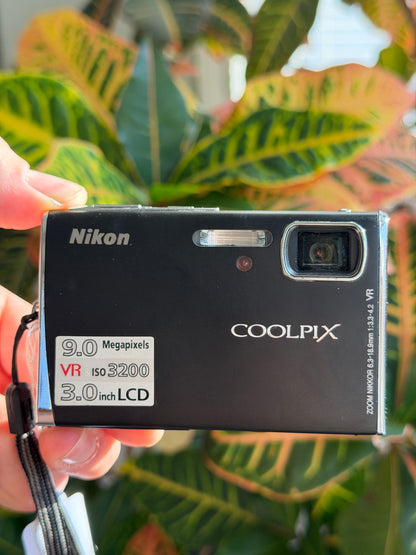 Nikon Coolpix S52 digital camera held in hand
