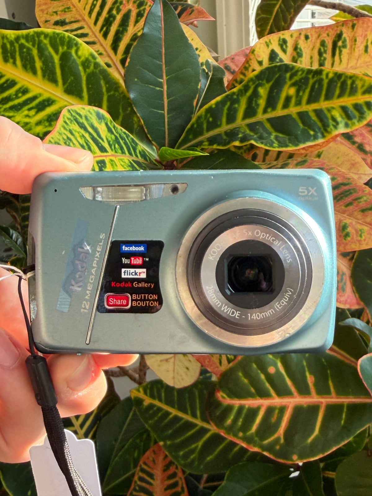 Kodak EasyShare M550 digital camera held in hand