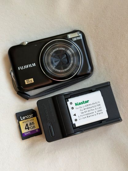 Fujifilm FinePix JX200 digital camera in black with battery, charger and memory card laid flat
