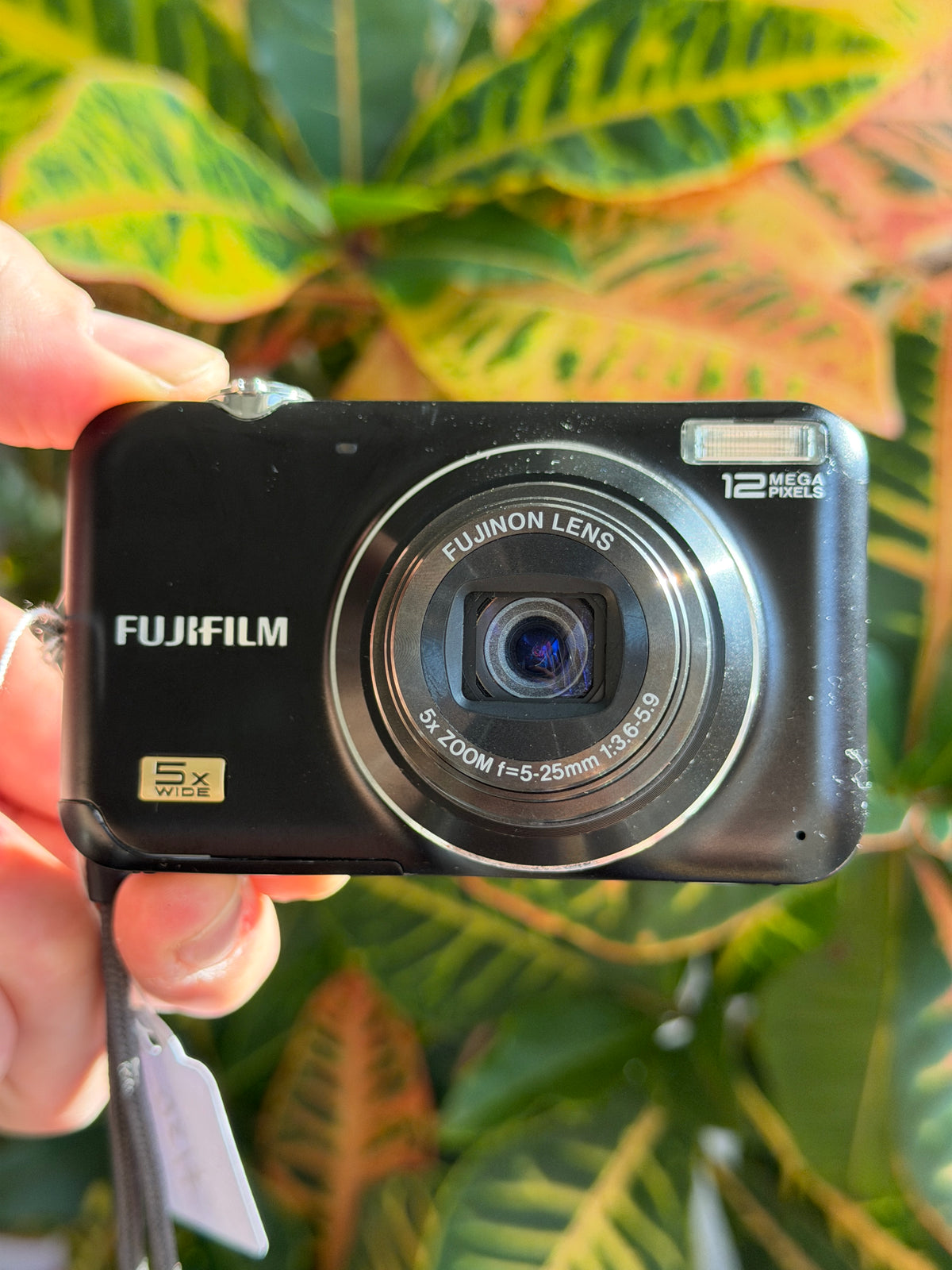 Fujifilm FinePix JX200 digital camera held in hand